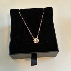 Gold necklace with stone.